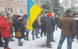 After walking out of work Feb. 14, coal miners in Donetsk region of Ukraine, joined by family members, protest at company headquarters during strike demanding payment of back wages.