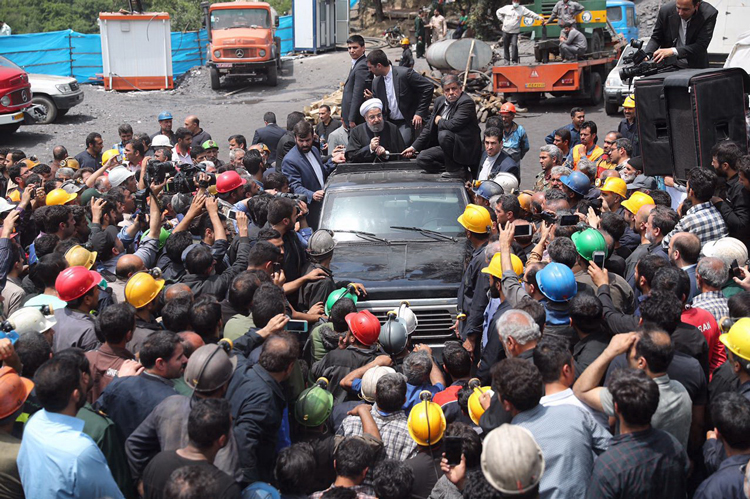 Iran’s President Hassan Rouhani, in car, surrounded by coal miners, Azadshahr, Iran, May 2017; 26 miners had been killed in May 3 mine collapse. Workers in Iran are taking advantage of factional divisions in ruling class to open more political space to speak and act.