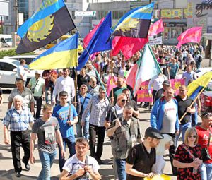Workers march on May Day in Kryvyi Rih, a major industrial center in Ukraine, in fight for pay raise, safe working conditions and new union contract at ArcelorMittal steel plant there.