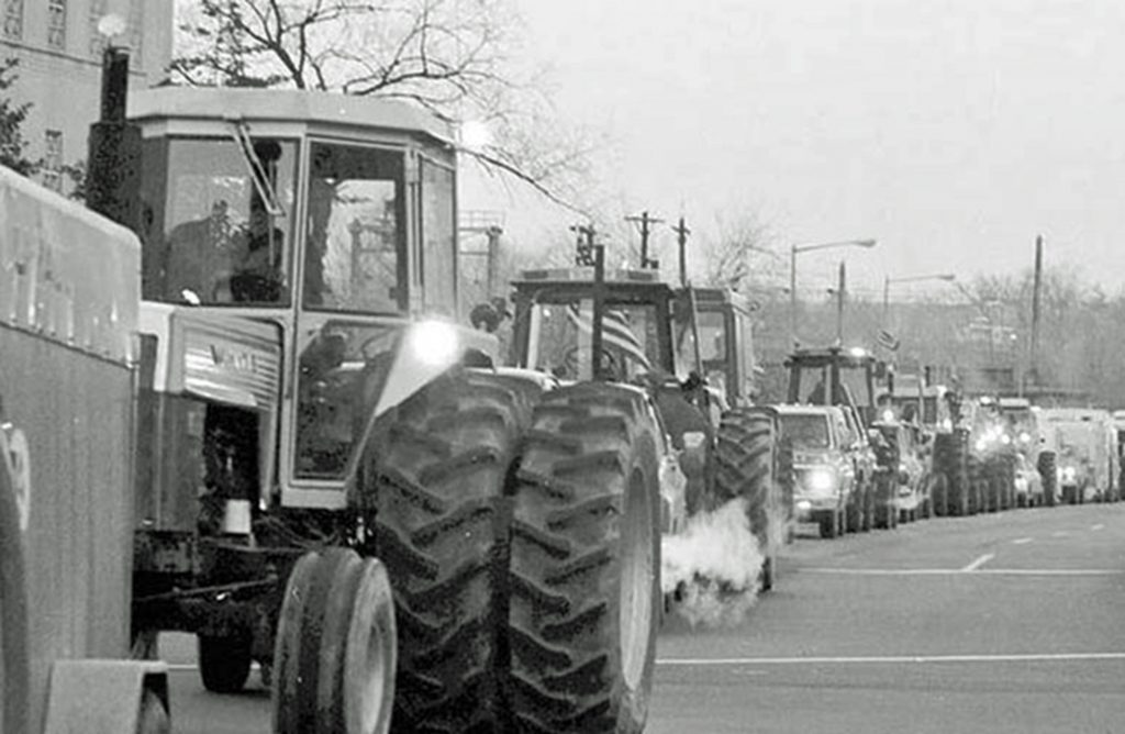Tractorcade by thousands of farmers from across country arrives in Washington, Feb. 5, 1979. Organized by American Agricultural Movement, farmers occupied National Mall for weeks demanding parity - guaranteed prices for their crops at least equal to costs of production.