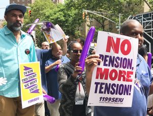 Local 1199 SEIU hospital workers picket Mt. Sinai Hospital in New York July 12, one of more than 100 actions statewide protesting bosses’ moves to cut pensions, medical care and training.