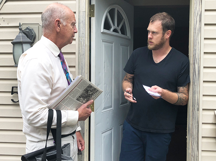 Dan Fein, left, Socialist Workers Party candidate for Illinois governor, talks with factory worker Jesse Bridges at his door while campaigning in Kankakee neighborhood July 29.