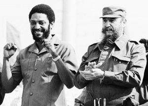 Maurice Bishop, left, and Fidel Castro at May Day rally in Cuba, 1980. “Grenada had become a true symbol of independence and progress in the Caribbean,” Fidel Castro said after Bishop was killed in counterrevolutionary coup. “No one could have foreseen the tragedy” to come.