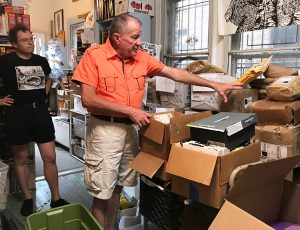 Tom Haney, right, with Philadelphia-based Books Through Bars, points to stacks of books returned by prison authorities because of new rules restricting prisoners’ right to receive them.