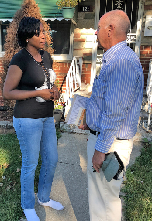 Dina Pickett, a teacher’s aide, speaks with Dan Fein, SWP candidate for Illinois governor, at her house in Bellwood.