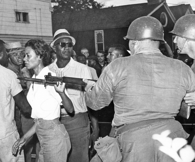 Civil rights fighter Gloria Richardson pushes aside National Guardsman’s bayonet at July 21, 1964, Cambridge, Maryland, protest. Crime rate dropped 75 percent after start of Black rights protests there. Working-class solidarity counters dog-eat-dog morality of capitalism.