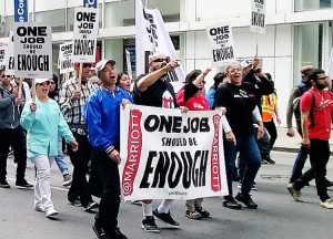 Hotel workers, members of UNITE HERE Local 2, march in San Francisco Sept. 3 after contract with Marriott hotels expired. Many are forced to work two jobs to make ends meet.