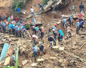 Miners join rescue workers to dig out victims buried in mudslide in Itogon, Philippines.