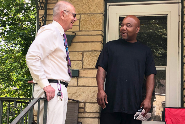 Dan Fein, Socialist Workers Party candidate for Illinois governor, talks with Willie Norwood, right, in Kankakee. Bedrock of party’s campaigning is going door to door to talk with workers
