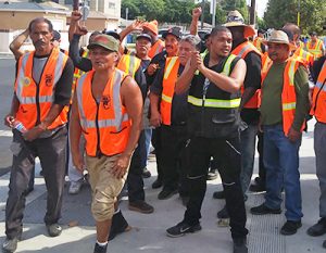 Cal Cartage warehouse workers join rally in Wilmington, California, Oct. 3, part of three-day strike alongside port drivers for right to join union. Strikers joined protest against White House order ending Temporary Protected Status for immigrants threatened with deportation.