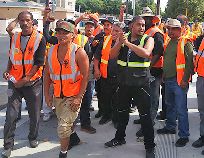 Cal Cartage warehouse workers join rally in Wilmington, California, Oct. 3, part of three-day strike alongside port drivers for right to join union. Strikers joined protest against White House order ending Temporary Protected Status for immigrants threatened with deportation. 