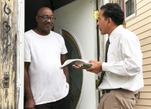 SWP member Róger Calero talks with Herman Freeman at his doorstep in Queens, Sept. 23.