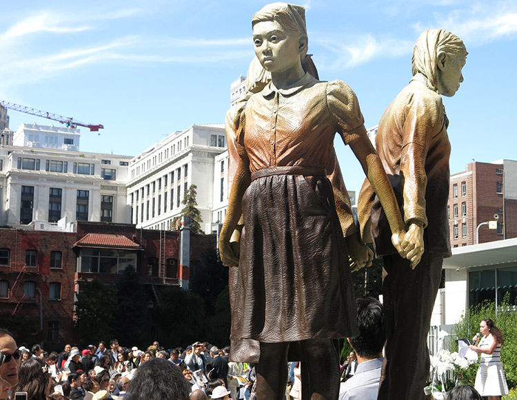 Above, San Francisco statue of “comfort women” who Japanese rulers kidnapped and forced into prostitution during second imperialist world war. Inset, 500 people attend Sept. 22 commemoration of statue’s unveiling. Osaka, Japan, mayor ended its sister-city relationship with San Francisco in retaliation for memorial.
