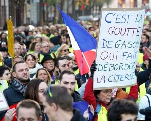 Over 250,000 demonstrators rallied throughout France Nov. 17 in an explosion of anger against rising gas prices. Sign says new taxes are “the drop of diesel that overflows the gas tank.”