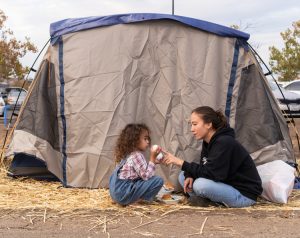 Fire survivors Rubyjade Stewart and son Rene, outside their tent in Chico Walmart lot Nov. 21.