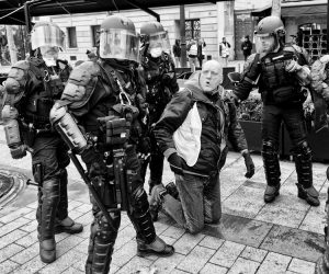 Police in France harass “yellow vest” protester at demonstration in Paris Nov. 24. Cops assaulted demonstration with tear gas and water cannons, affecting thousands of protesters.