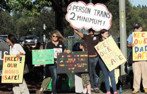 July 2014 protest in Seattle by rail workers and family members against bosses’ attempts to slash train crews down to one worker. Bosses seek to increase profits by attacks on workers, farmers and their conditions.