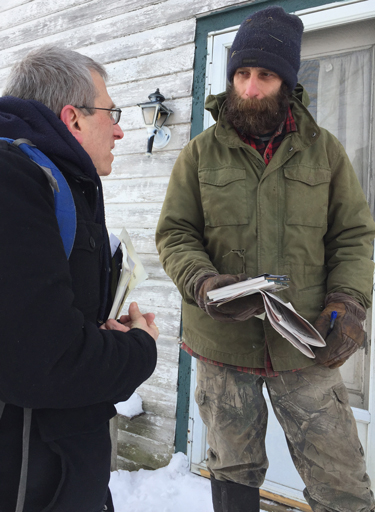 Peter Hula, right, in Richfield Springs, talks with SWP candidate Seth Galinsky about catastrophe dairy farmers face after years of milk prices below cost of production.