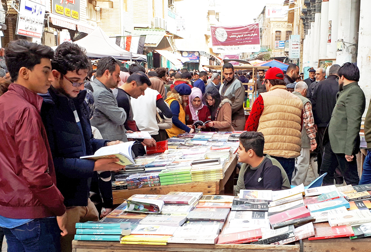 Al-Mutanabbi Street, Baghdad’s historic booksellers’ district, on a typical packed Friday Feb. 8. The stalls display books of every kind, political and not, in Arabic, English and other languages.