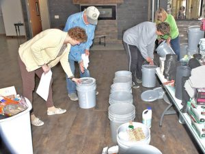 Volunteers from McCook, Nebraska, organize “flood buckets” of supplies to take to areas battered by flooding. Government officials had left those hard hit to fend for themselves.