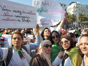 Teachers hold placards outside Algiers post office March 13, reading at left, “You have millions. We are millions of teachers” and in center, “I dream of a democratic Algeria.”