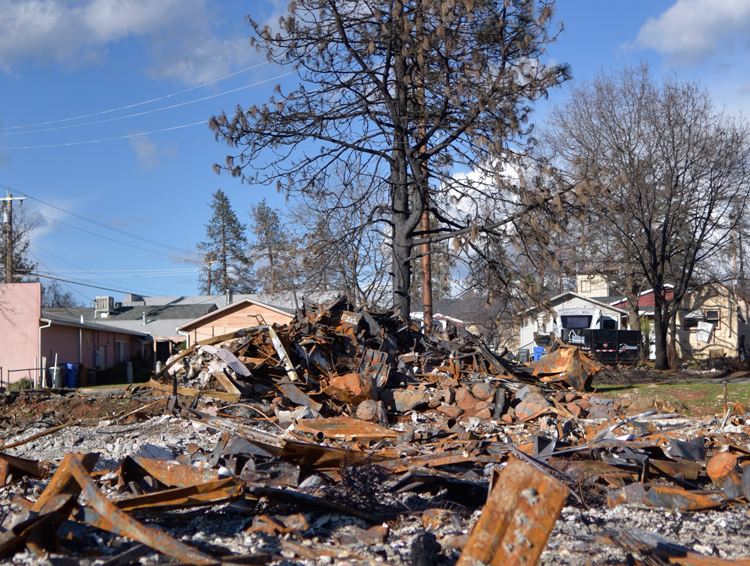 Rubble of Paradise building burned by wildfire four months ago sits untouched. Residents are still denied right to return to any properties with burn damage.