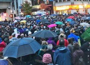 Overflow crowd at Pittsburgh vigil Oct. 27, 2018, after murder of 11 Jews at synagogue there. Inset, Rabbi Alexander Davis speaks at rally at Dar Al Farooq Islamic Center, Bloomington, Minnesota, Aug. 8, 2017, following bombing of mosque. Many Somali workers in that area say they recall the support they got from Jews there and oppose Rep. Ilhan Omar’s recent anti-Semitic slanders.