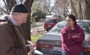 Bianca Alvarado, right, talks with Jeff Powers in Chico, California, in February after wildfire destroyed nearby Paradise, killing scores. Fire was caused by PG&E bosses’ disdain for safety.