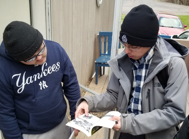 Socialist Workers Party campaigner Sergio Zambrana, right, talks with aerospace worker Kyle Miller at Miller’s doorstep in Peru, New York, April 27, about party’s program and activities.