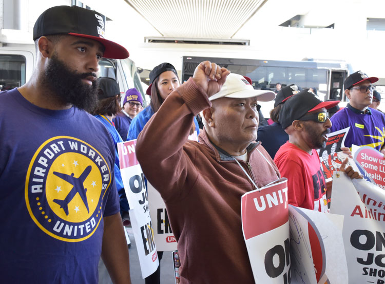 Chanting “One job should be enough!” airport workers as well as Sky Chef and Gate Gourmet workers picket together at San Francisco International Airport for higher wages, new contracts.