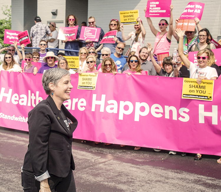 Crowd greets May 31 restraining order against closing of Missouri’s only family planning clinic providing abortion. In foreground, Missouri Planned Parenthood officer M’Evie Mead.