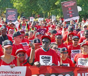 Hundreds of airline catering workers, working for LSG Skychefs, rally near American Airlines headquarters by Dallas-Fort Worth airport Aug. 13, demanding wage raises and new contract.