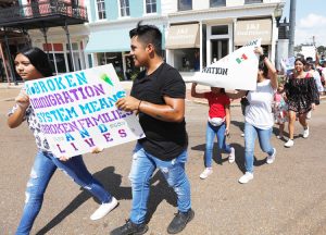 “We march so no other kid has to go through what we did,” 18-year-old Dulce Basurto-Arce said at Aug. 11 protest in Canton, Mississippi. Some signs read, “Our parents are not criminals.”