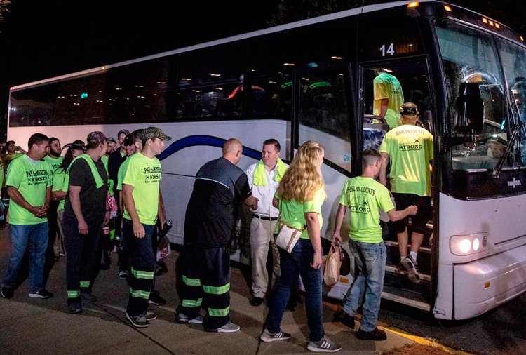 Miners in Harlan County, Kentucky, get on bus to attend Blackjewel Coal bankruptcy hearing Aug. 5 in Charleston, West Virginia, wearing T-shirts saying “Pay the miners first, lawyers last.”