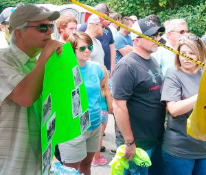 Ned Measel, left, brought greetings on poster from co-workers at Kentucky Walmart to the coal miners, backing their fight.