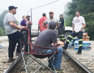 Coal miners and supporters block rail tracks at mine near Cumberland, Kentucky, to prevent Blackjewel Coal from shipping coal until company pays miners wages they are owed.