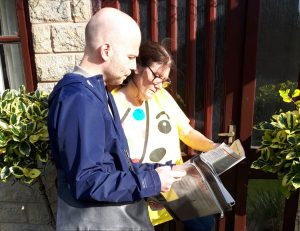 Hugo Wils speaking with school kitchen worker Lesley Kirkham in Whaley Bridge, England, Aug. 17. Damage of nearby dam was “caused by capitalists’ drive for profits,” said Wils.