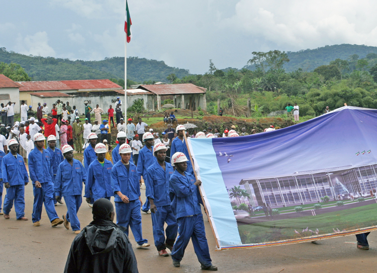 Workers in Equatorial Guinea at Chinese-run construction project march at Oct. 12, 2005, independence day parade in Evinayong. Growth of oil industry has expanded the capitalist class and above all, a working class that has growing self-confidence, pride and a widening scope.