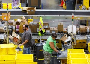 Workers at Amazon warehouse in Chattanooga, Tennessee, 2017. Retail rivals Walmart and Amazon are ramping up the pressure on workers as they compete for ever faster deliveries.
