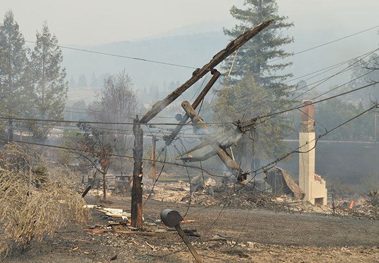 Burned, mangled power lines in Santa Rosa, California, Oct. 2017. PG&E faces millions of dollars in damages over responsibility for fire for poor maintenance, failure to clear vegetation.