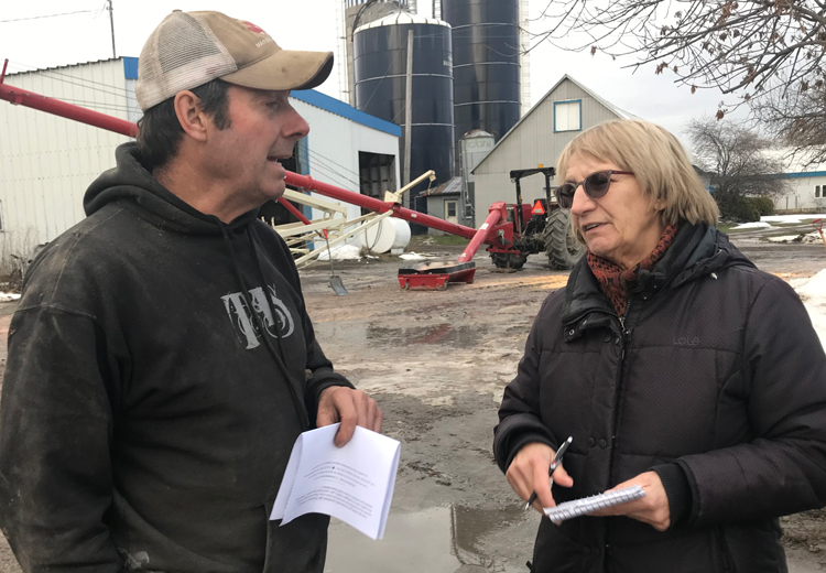 Militant correspondent Sylvie Charbin talks with Pierre Robidoux on his farm outside Montreal Nov. 24 about CN rail workers strike. Robidoux said he appreciated discussion on need for alliance of farmers and workers, saying big business media “doesn’t care what we think.”