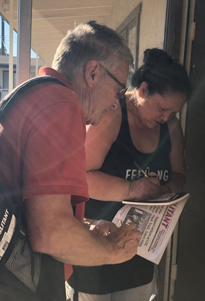 Gloria Saenz purchases subscription to Militant Oct. 26 after discussing Asarco copper miners strike with SWP member Bernie Senter on her doorstep in Whittier, California.