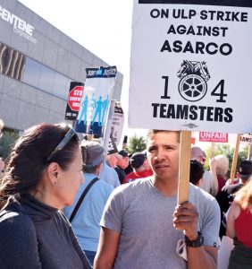 Roberto Banegas, a heavy equipment operator at Asarco’s Mission Mine in Arizona, on strike for pay raise and against company effort to break union, talks with Socialist Workers Party member Ellie Garcia at solidarity rally in Tucson, Nov. 18.