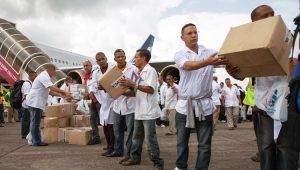 Cuban medical volunteers unload supplies on arrival in Freetown, Sierra Leone, Oct. 2014.