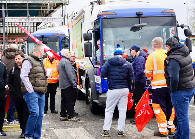 Sanitation workers, members of Unite union on strike in south-east London, stop refuse truck March 18. Two-day walkout won sick pay. Workers are also demanding end to multitier wages.