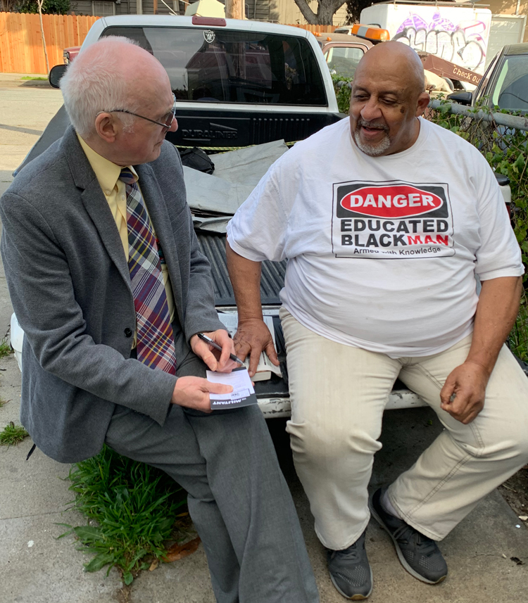 Joel Britton, left, SWP candidate for U.S. Congress, talks with former firefighter Bruce Johnson about fight against industrial contamination in West Oakland neighborhood.