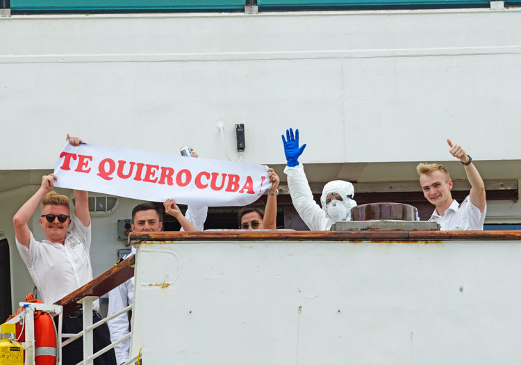 MS Braemar crew members hold sign, “I love you Cuba,” after Cuban government let ship dock March 18 with passengers with coronavirus, after other Caribbean nations denied it entry.