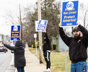 Workers, members of Communications Workers of America, protest outside General Electric jet engine plant in Lynn, Massachusetts, March 30, demanding GE urgently convert production to life-saving ventilators, not lay off thousands of assembly line and maintenance workers.