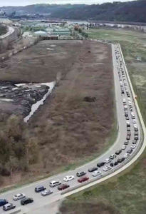 Miles of cars wait to get to Pittsburgh community food bank March 30. Tini Mason, 44, just out of job as a cook, said it was a “mind-blowing experience I will never forget.”