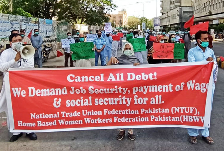 Factory, textile and garment workers demonstrate in Karachi, Pakistan, April 18, demanding end to firings by bosses, for payment of wages for workers at plants that are shut down.